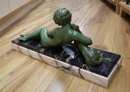 An Art Deco green patinated bronze figure of a reclining lady with a dog, on marble plinth, signed L Bruns